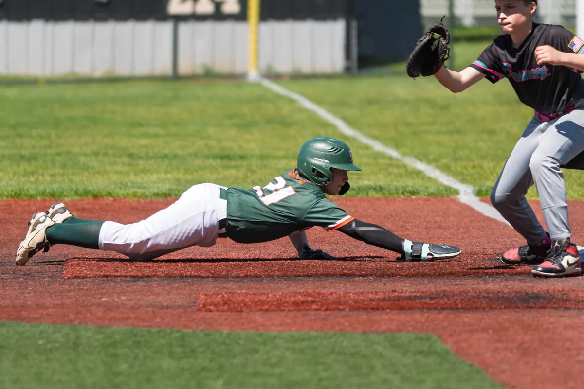 A Hurricanes runner diving headfirst back to the bag